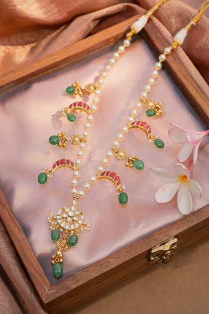 JADAU ON SILVER CHAAND PENDANT STRUNG IN MOTI MAALA WITH MULTI-RED CHAANDS